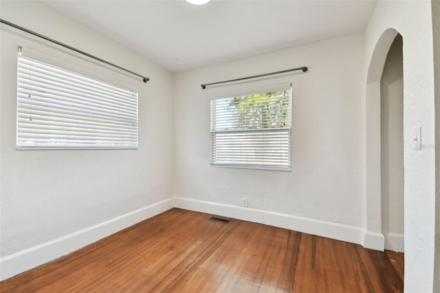 unfurnished room with hardwood / wood-style floors