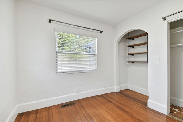 unfurnished bedroom with hardwood / wood-style flooring