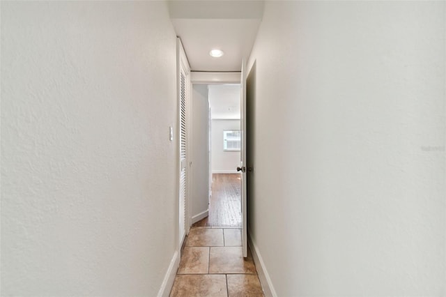 hallway with light tile patterned floors