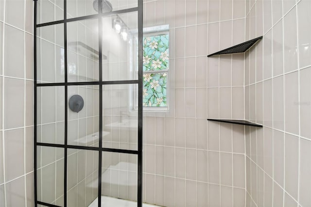 bathroom with tiled shower