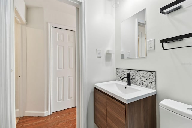 bathroom featuring hardwood / wood-style floors, vanity, and toilet