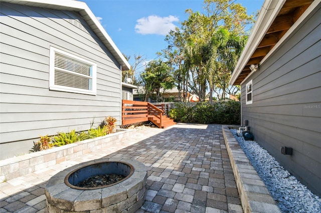 view of patio / terrace featuring a fire pit and a deck