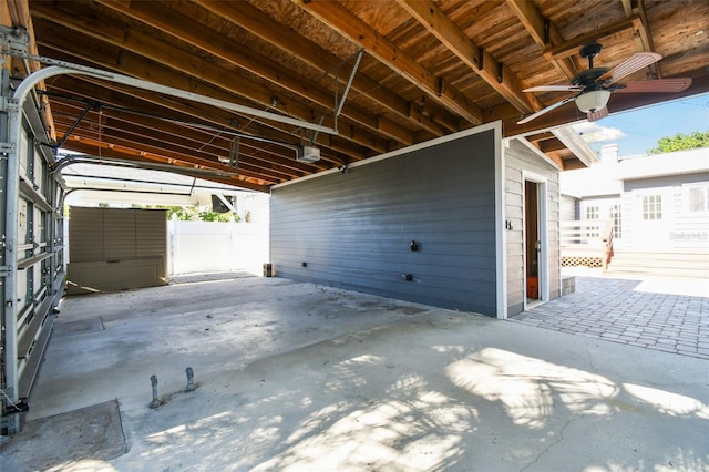 garage featuring ceiling fan and a garage door opener