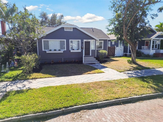 bungalow-style house featuring a front yard