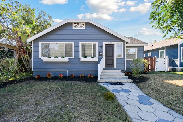 bungalow-style home featuring a front lawn