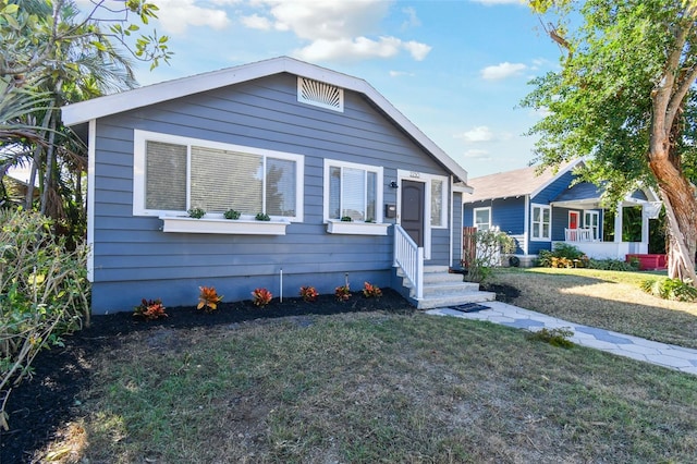 bungalow-style home featuring a front yard