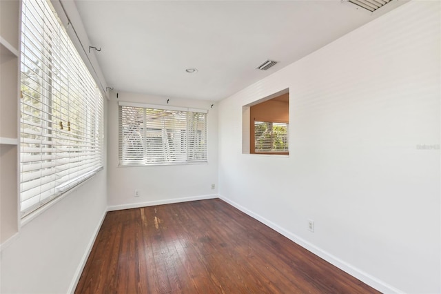 empty room with dark hardwood / wood-style floors