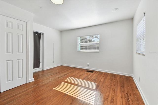 unfurnished bedroom with hardwood / wood-style flooring