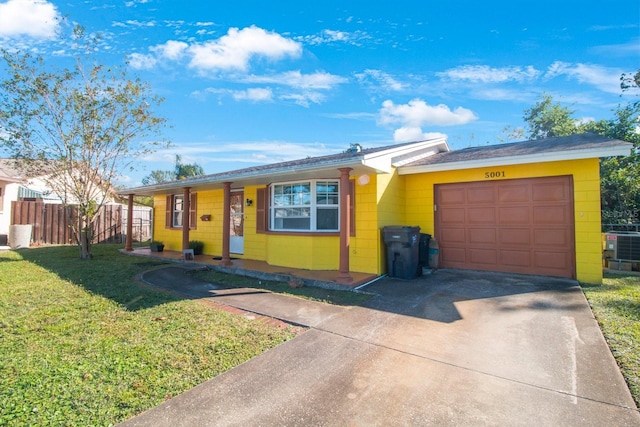 ranch-style house featuring central air condition unit, a front lawn, and a garage