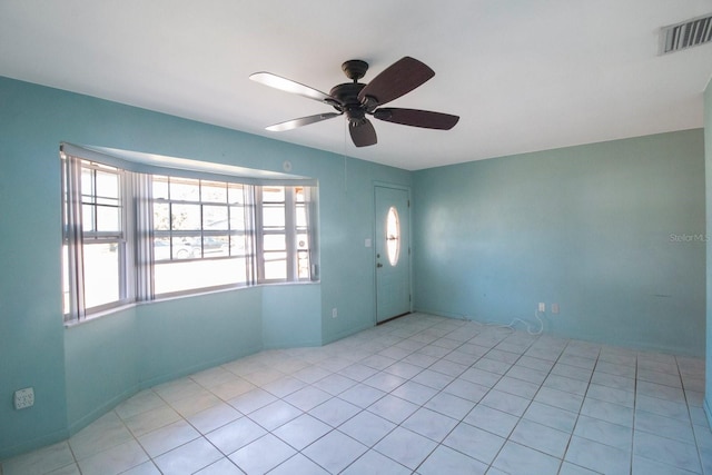 tiled empty room featuring ceiling fan