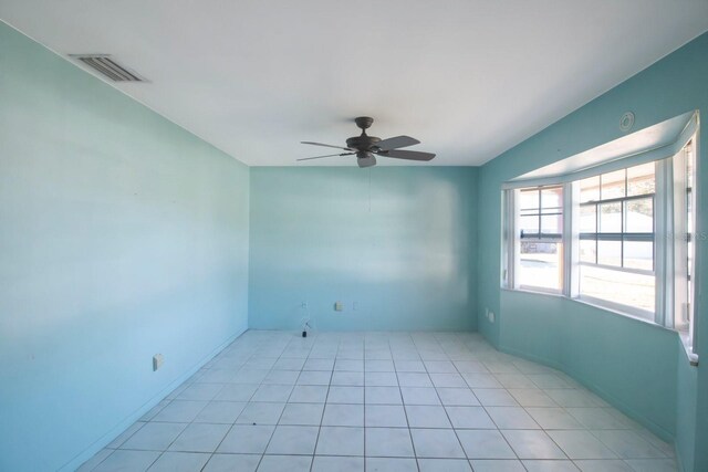 unfurnished room featuring ceiling fan and light tile patterned floors