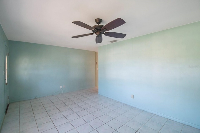 empty room featuring ceiling fan and light tile patterned flooring