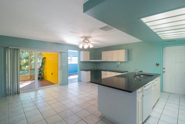 kitchen with kitchen peninsula, white dishwasher, ceiling fan, sink, and white cabinetry