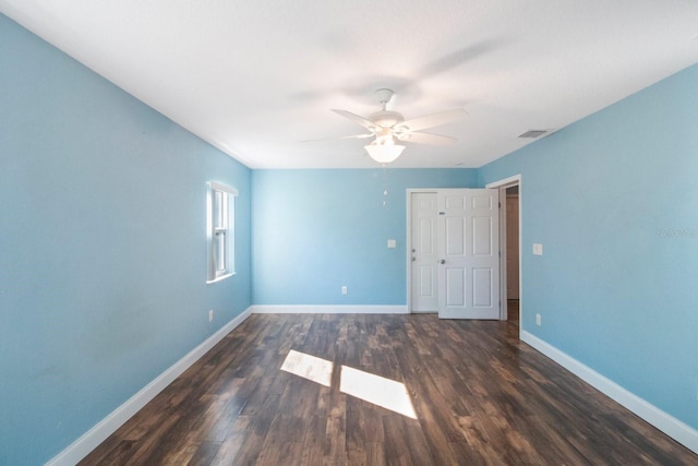 unfurnished room with ceiling fan and dark wood-type flooring