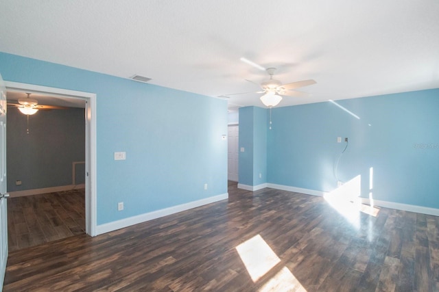 spare room with ceiling fan and dark wood-type flooring