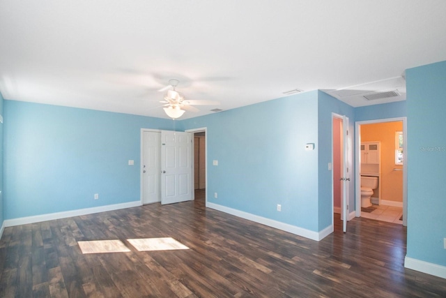 empty room with ceiling fan and dark hardwood / wood-style flooring