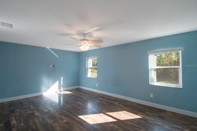 spare room featuring a textured ceiling, ceiling fan, and dark hardwood / wood-style floors