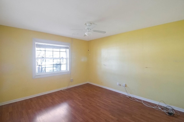 spare room featuring ceiling fan and dark hardwood / wood-style flooring