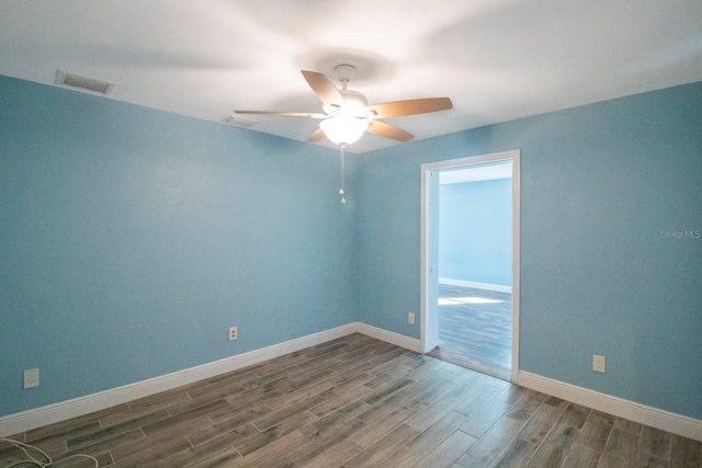 empty room featuring hardwood / wood-style floors and ceiling fan