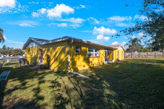 view of side of home featuring a lawn