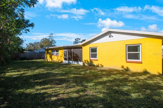 rear view of house with a yard