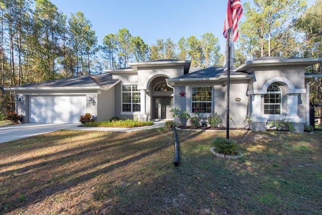 view of front of property with a front yard and a garage