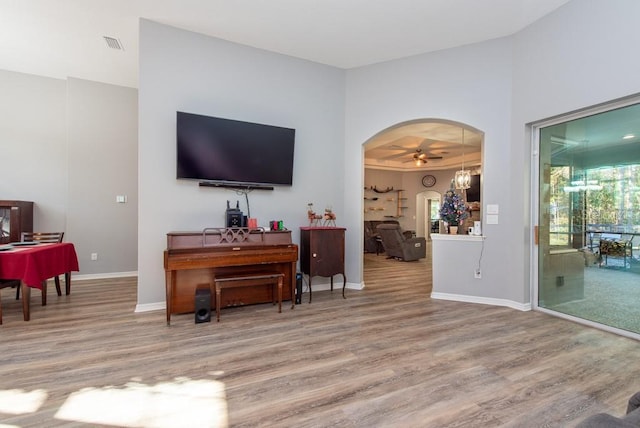 living room with ceiling fan and wood-type flooring