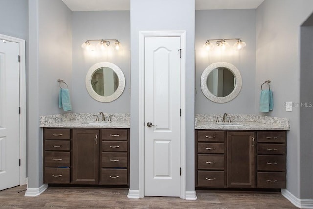 bathroom with vanity and hardwood / wood-style flooring