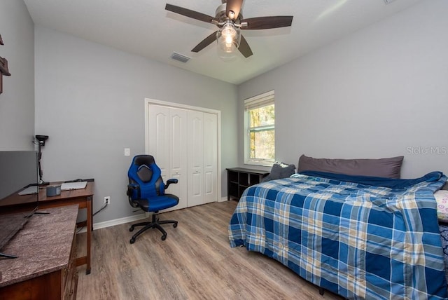 bedroom featuring hardwood / wood-style floors, a closet, and ceiling fan