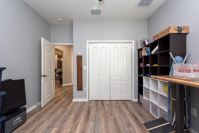 interior space featuring hardwood / wood-style floors and a closet