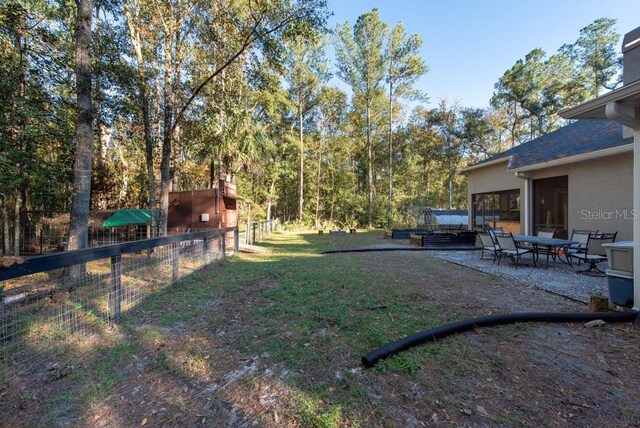 view of yard with a shed and a patio