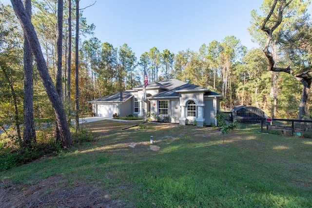 single story home featuring a front lawn and a garage