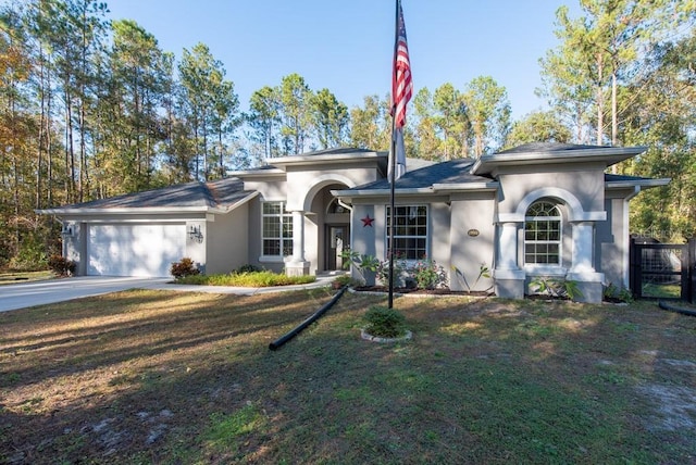 view of front of property with a front lawn and a garage