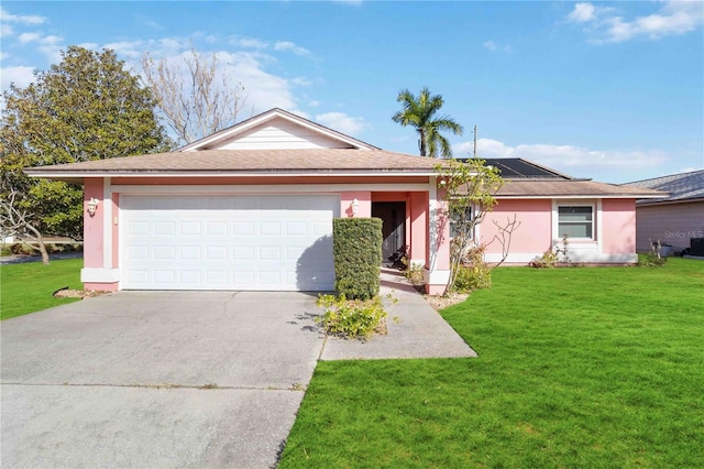 single story home with a garage and a front lawn