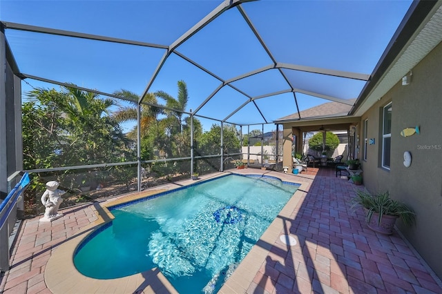 view of pool with a patio and glass enclosure