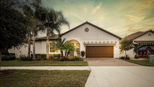 view of front of home with a lawn and a garage