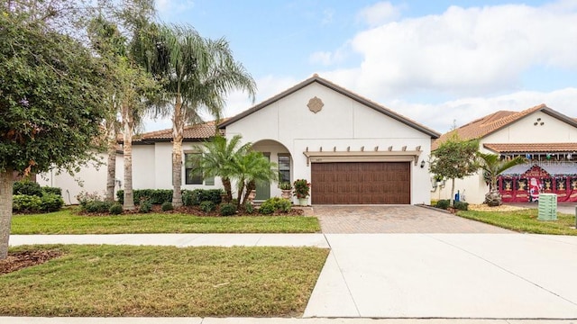 view of front of home with a garage and a front lawn