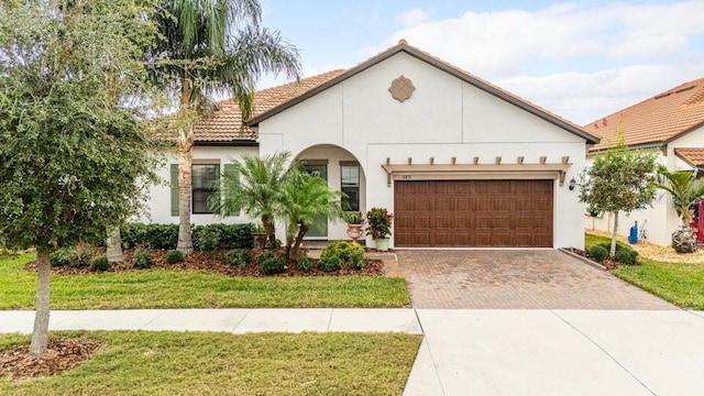 view of front of property with a front lawn and a garage