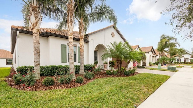 mediterranean / spanish-style house with a front lawn