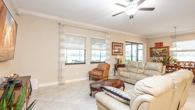 living room with light tile patterned floors, ceiling fan, and ornamental molding