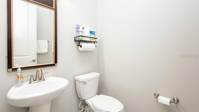 bathroom with toilet and sink