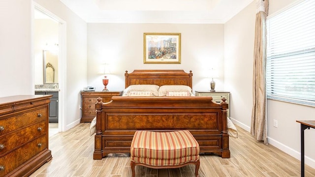 bedroom featuring ensuite bath and ornamental molding