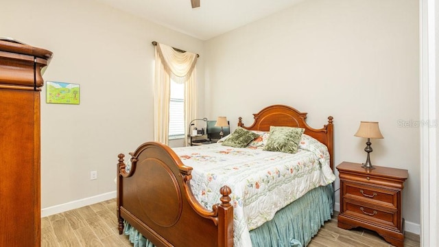 bedroom with ceiling fan and light hardwood / wood-style flooring