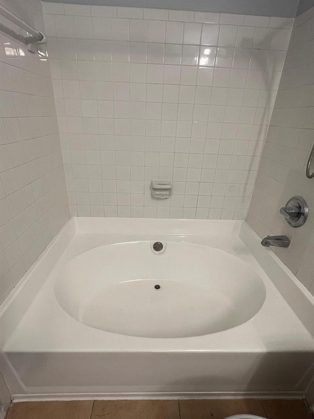 full bath featuring tile patterned floors, a shower, and a tub