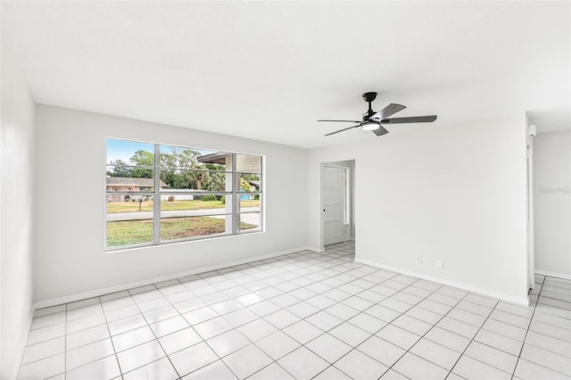 tiled empty room with ceiling fan