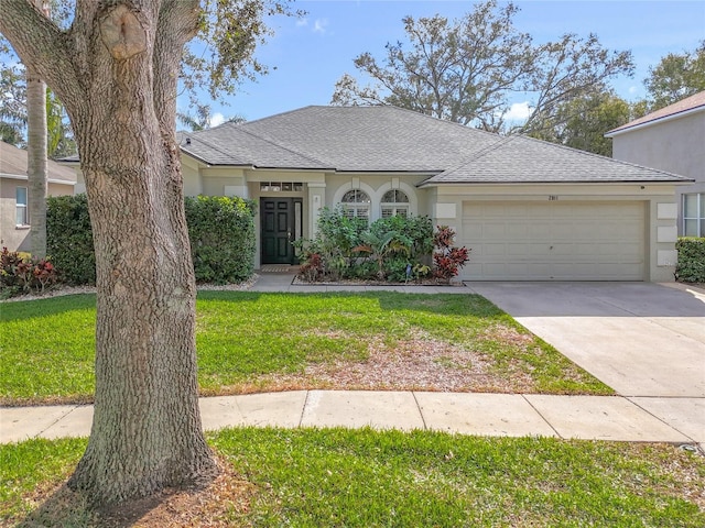 view of front of property featuring a front lawn and a garage