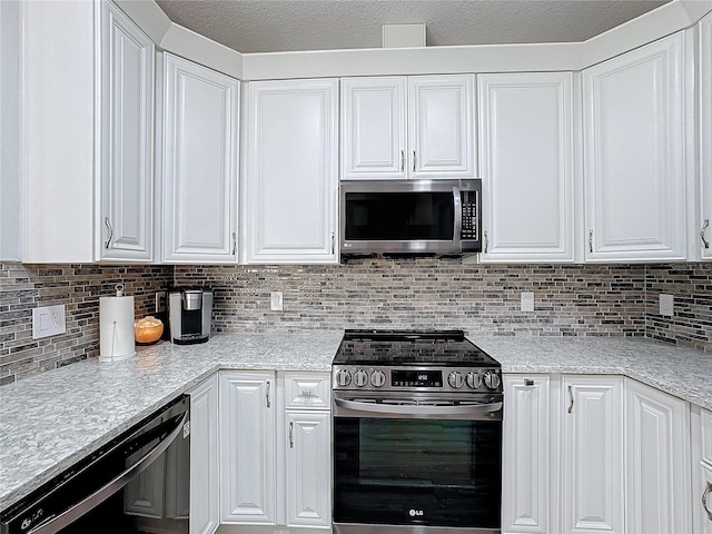 kitchen with white cabinetry, appliances with stainless steel finishes, and tasteful backsplash