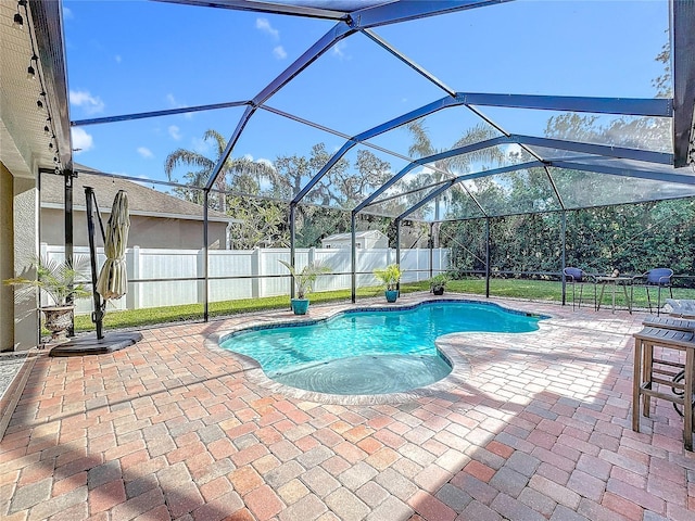 view of pool with a patio area and a lanai