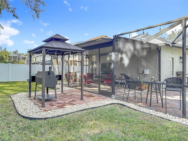 back of house featuring a patio area and a lawn