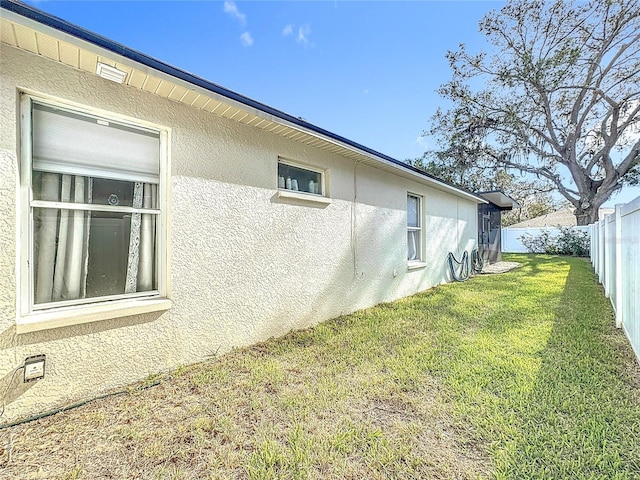 view of side of property with a yard